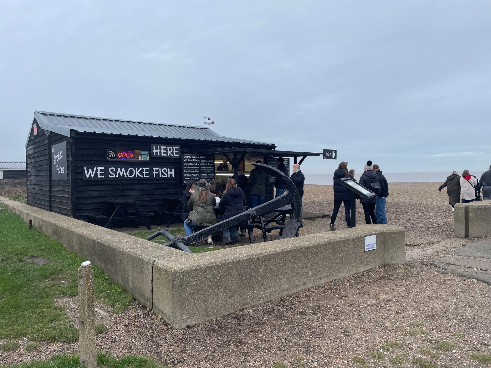 a hut on a beach selling smoked fish